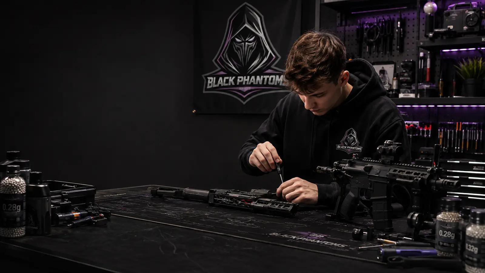 A Black Phantoms technician working on an AEG at the bench